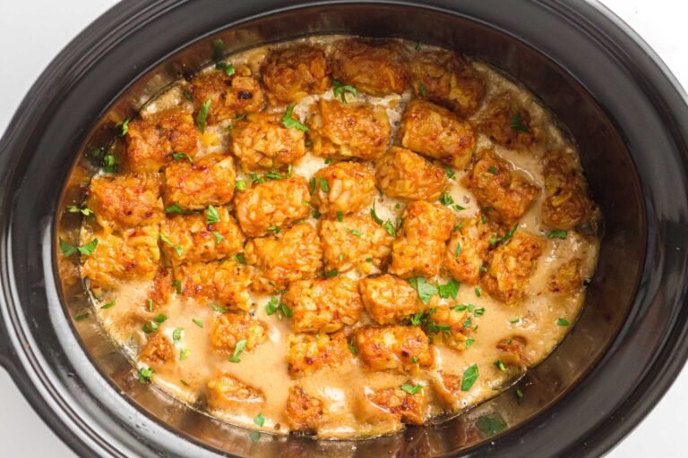 Slow cooker cowboy casserole topped with crispy tater tots and parsley.