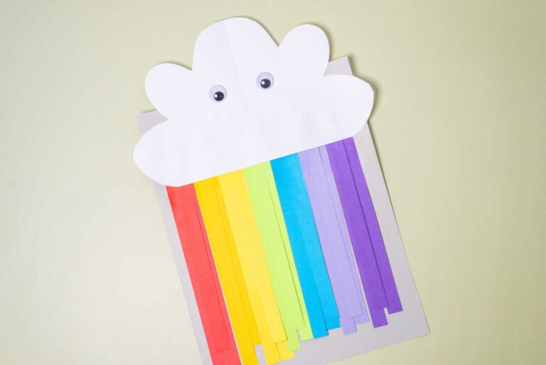 Cute rainbow cloud craft with colorful paper strips and googly eyes cloud face