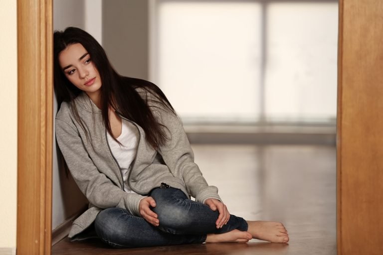 Woman grieving alone with affirmations for grieving.