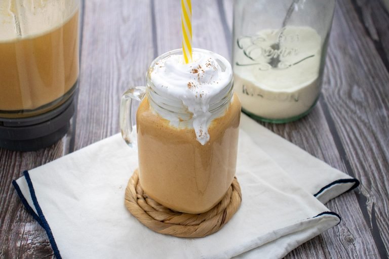 Pumpkin Spice Protein Shake topped with whipped cream and warm pumpkin spice.